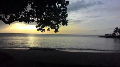 a view of the ocean with the sun setting on the beach at Casa de las Mariposas - near the beach in Río San Juan