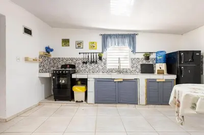 a kitchen with blue doors and a counter top at Casa de las Mariposas - near the beach in Río San Juan