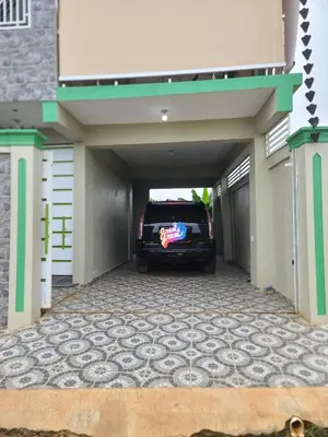 a car is parked inside of a garage at Apartahotel Henry Winche in Sabana Grande de Boyá