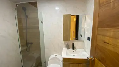 a bathroom with a shower and a sink and a mirror at Apartamento San Pedro Colonial in San Pedro de Macorís