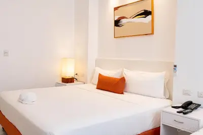 a bedroom with a white bed with a phone on it at Hotel Stars Bávaro hab 102 in Punta Cana