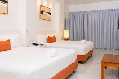 a hotel room with two beds and a table at Hotel Stars Bávaro hab 102 in Punta Cana