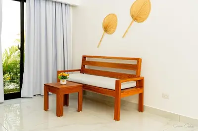 a wooden bench sitting in a room with a window at Hotel Stars Bávaro hab 102 in Punta Cana