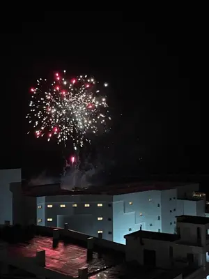 a building with fireworks exploding in the sky at night at MarMary Ocean view by Marina in Boca Chica