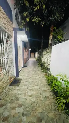 an empty hallway with a stone walkway at night at beach apartment cafe del sol in La Puntica de Juan Dolio