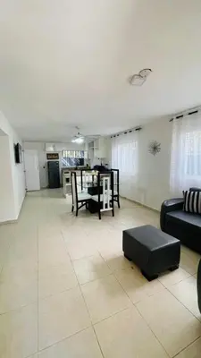a living room with a couch and a table at beach apartment cafe del sol in La Puntica de Juan Dolio
