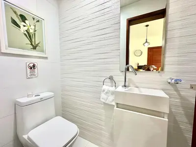 a bathroom with a white toilet and a sink at Soha Suites II Deluxe in Colorado