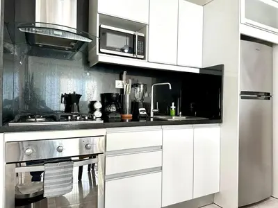 a white kitchen with a sink and a microwave at Soha Suites II Deluxe in Colorado