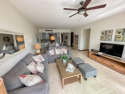 a living room with couches and a flat screen tv at Portillo Residences, El Limon, Luxury Apartment in El Limón