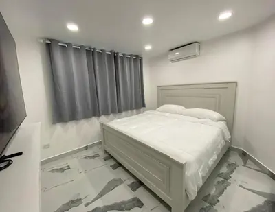 a bedroom with a white bed and a window at Crystal Pool Oasis in Sosúa