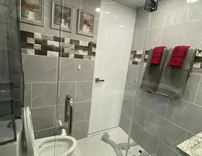 a bathroom with a shower stall and a toilet at Crystal Pool Oasis in Sosúa