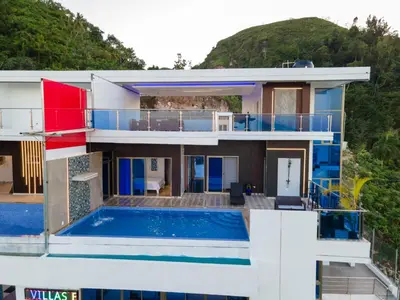 a villa with a swimming pool and a house at Villas Escape in Las Terrenas