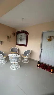 a room with four chairs and a white door at El rincón de Sánchez in Moca