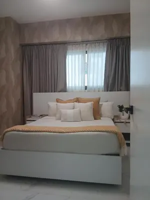 a bedroom with a large white bed with pillows at Downtown, Cozy and Modern! in Santo Domingo