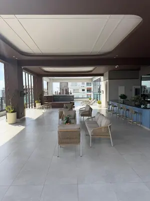 a lobby with chairs and tables in a building at Downtown, Cozy and Modern! in Santo Domingo