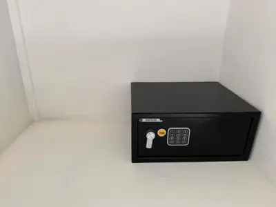 a black microwave in a corner of a room at Blue Oasis Luxury in Sosúa