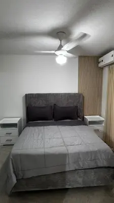 a bedroom with a bed and a ceiling fan at New and Comfortable Apartment in Ciudad Juan Bosch in San Isidro