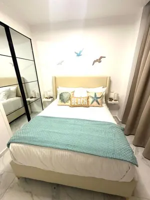 a bedroom with a large bed with a mirror at New Jacuzzi Beach Fun 2 bedroom at Cana Rock Star in Punta Cana