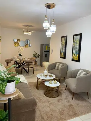 a living room with a couch and chairs and tables at Isidro 102 Comfrot Stay in San Isidro