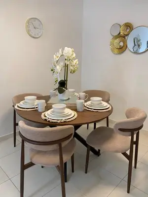 a dining room table with chairs and a vase of flowers at Isidro 102 Comfrot Stay in San Isidro