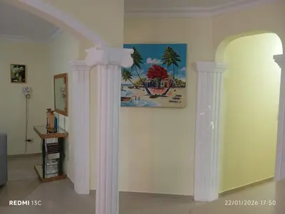 a room with white columns and a painting on the wall at Casa vacanza, Mendosa in Bayaguana