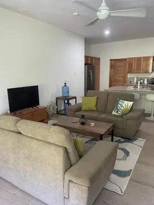 a living room with a couch and a table at Pro Cab Apartment - Washer - BBQ in Cabarete