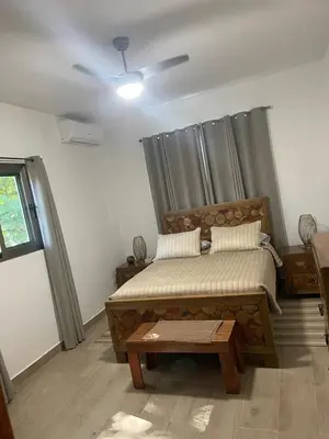 a bedroom with a bed and a ceiling fan at Pro Cab Apartment - Washer - BBQ in Cabarete