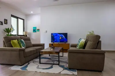 a living room with two couches and a tv at Pro Cab Apartment - Washer - BBQ in Cabarete