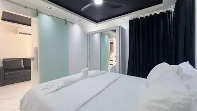 a bedroom with a large white bed with a ceiling at One Bedroom Apartment - Wi-Fi - BBQ in Sosúa