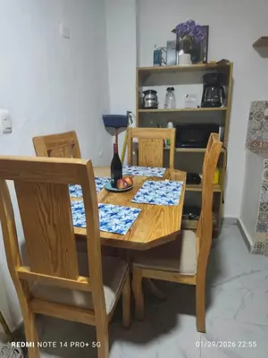 a dining room table and chairs with a bottle of wine at housing Freddy in Santo Domingo