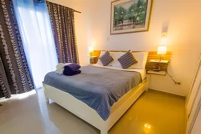 a bedroom with a bed in a room with a window at Los Corales Moderno Apto: Piscina y Playa 10 min in Punta Cana