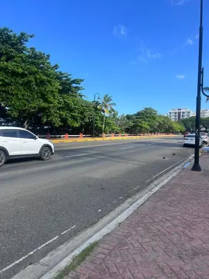 a white car driving down a city street at Bijoc 01 Apartment in San Felipe de Puerto Plata