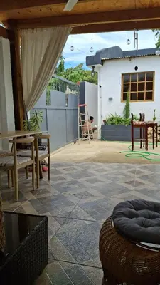 a patio with a table and benches and a house at Villa Manuel Rodriguez