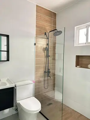 a bathroom with a shower with a toilet and a sink at Beach front apartment in Puerto Plata