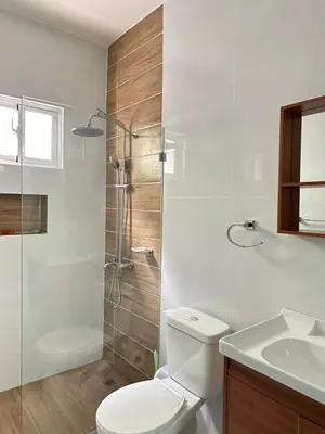 a bathroom with a toilet and a shower and a sink at Beach front apartment in Puerto Plata