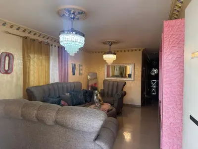 a living room with two couches and chandeliers at Recidencial Laurel in Baní