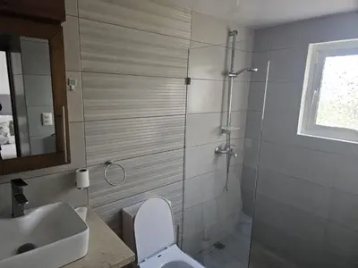 a bathroom with a shower and a toilet and a sink at Cristamar in Cabarete
