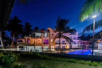 a villa with a swimming pool at night at Cristamar in Cabarete