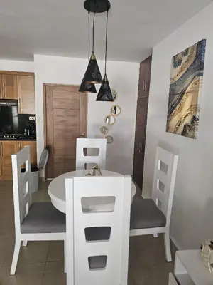 a dining room with a white table and chairs at Cristamar in Cabarete