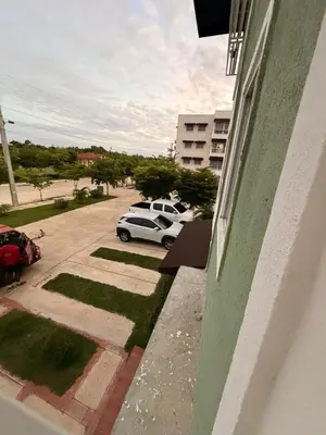 a car parked in a parking lot next to a building at Super Apartment 10 mn to the Int Airport