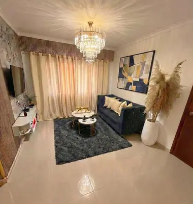 a living room with a couch and a chandelier at Super Apartment 10 mn to the Int Airport