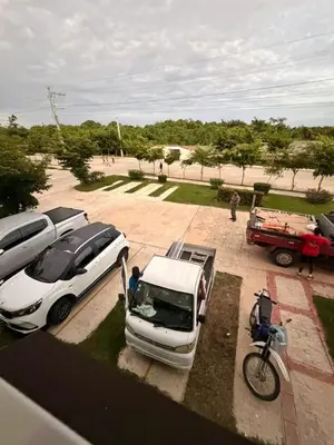a white car parked in a parking lot with a motorcycle at Super Apartment 10 mn to the Int Airport