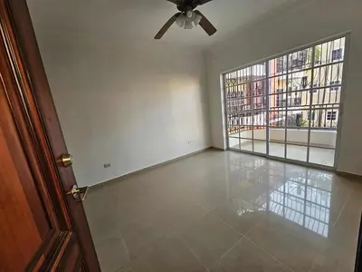 an empty room with a ceiling fan and a large window at apartamiento reyes in Pantoja