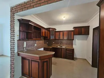 a kitchen with wooden cabinets and a counter top at apartamiento reyes in Pantoja