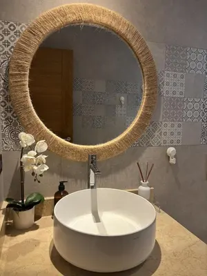 a bathroom with a large round mirror and a tub at Garden Breeze Pool & Beach Escape l Bali 102 in La Laguna