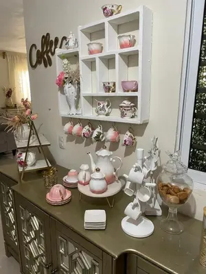 a room with a shelf filled with pink tea sets at My Little House in Constanza