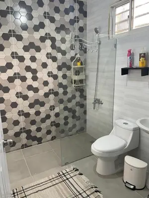 a bathroom with a toilet and a glass shower at My Little House in Constanza