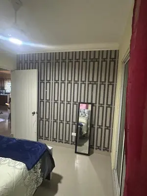 a bedroom with a bed and a mirror on the wall at Garden view paradise La Vega in Concepción de La Vega