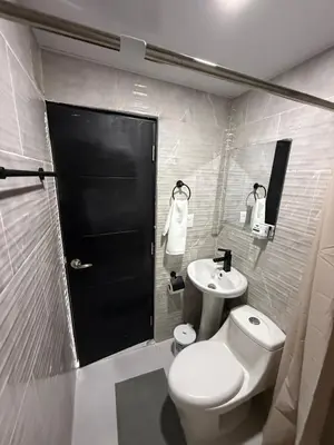a bathroom with a white toilet and a sink at Moon Apartamento C2 in San Cristóbal