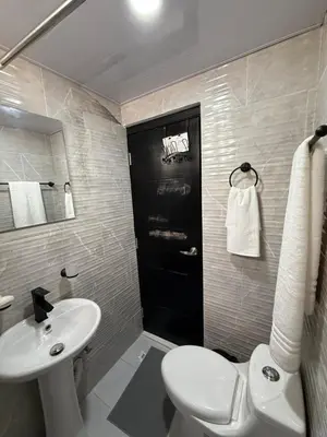 a bathroom with a white sink and a toilet at Moon Apartamentos D2 in San Cristóbal